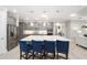 Modern kitchen with gray cabinetry, stainless steel appliances, oversized island, and pendant lighting at 9270 Sw 89Th Street Rd, Ocala, FL 34481