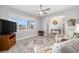 Inviting living room with large window, ceiling fan, and open entryway to another room at 9270 Sw 89Th Street Rd, Ocala, FL 34481