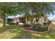 Beautiful backyard featuring lush landscaping, mature trees, and a screened lanai, creating a serene outdoor retreat at 9274 Sw 94Th Loop, Ocala, FL 34481