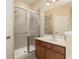 Bathroom featuring walk-in shower, vanity with sink, and neutral tiling at 9274 Sw 94Th Loop, Ocala, FL 34481