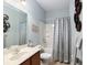 This lovely bathroom features a vanity, a tub/shower combo with a curtain, and decor at 9274 Sw 94Th Loop, Ocala, FL 34481