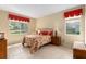 Comfortable bedroom with large windows and decorative red accents at 9274 Sw 94Th Loop, Ocala, FL 34481