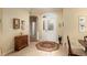 Bright foyer with decorative rug and antique furniture, leading to other rooms in the home at 9274 Sw 94Th Loop, Ocala, FL 34481