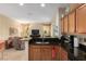 Open kitchen area showcasing granite countertops and a seamless view into the living room at 9274 Sw 94Th Loop, Ocala, FL 34481