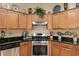 Close-up of kitchen with granite counters, stainless steel oven, and decorative accents at 9274 Sw 94Th Loop, Ocala, FL 34481