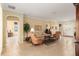 Cozy living room with tile floors, neutral paint, comfortable seating, and an archway to another room at 9274 Sw 94Th Loop, Ocala, FL 34481