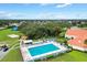 Aerial view of a large community pool with ample seating and a recreation facility at 9750 Se 179Th Pl, Summerfield, FL 34491