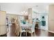 Bright dining room with hardwood floors, neutral paint, and an open floor plan to the kitchen and living room at 9750 Se 179Th Pl, Summerfield, FL 34491