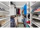 Spacious walk-in closet featuring custom shelves and ample storage for shoes and accessories at 9750 Se 179Th Pl, Summerfield, FL 34491