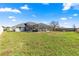 Backyard view featuring screened-in pool and lanai at 10100 Se 69Th Ave, Belleview, FL 34420