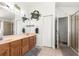 Bathroom featuring a double sink vanity, tile flooring, and a glass-enclosed shower at 10100 Se 69Th Ave, Belleview, FL 34420