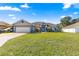 Charming single-story home with lush front lawn, blue trim, and well-manicured landscaping at 10100 Se 69Th Ave, Belleview, FL 34420