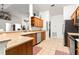 Well-lit kitchen featuring tile flooring, stainless steel appliances, and wood cabinetry at 10100 Se 69Th Ave, Belleview, FL 34420