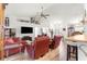 Spacious living room featuring modern flooring, ceiling fan, and neutral wall paint at 10100 Se 69Th Ave, Belleview, FL 34420