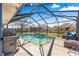 Enjoy the Florida lifestyle with a screened-in pool, grill, and outdoor seating at 10100 Se 69Th Ave, Belleview, FL 34420