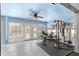 Enclosed sunroom used as a home gym with weightlifting equipment and an outdoor view at 10100 Se 69Th Ave, Belleview, FL 34420