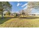 Expansive backyard view with mature trees and a well-maintained lawn and landscaping at 1029 Sw 157Th Ln, Ocala, FL 34473