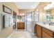 Bright bathroom featuring dual sinks, a glass enclosed shower and well lit vanity area at 1029 Sw 157Th Ln, Ocala, FL 34473