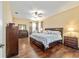 Spacious bedroom featuring wood floors, ceiling fan, and stylish furnishings at 1029 Sw 157Th Ln, Ocala, FL 34473