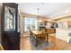 Cozy dining room features a wooden table, classic chandelier, and view of the kitchen at 1029 Sw 157Th Ln, Ocala, FL 34473