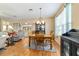 Bright dining area with wood floors, a classic chandelier, and view to the living room at 1029 Sw 157Th Ln, Ocala, FL 34473