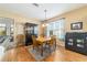 Cozy dining area with wood table set, display cabinet, and natural light from the window at 1029 Sw 157Th Ln, Ocala, FL 34473