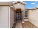 Inviting entryway featuring decorative pillars and a storm door at 1029 Sw 157Th Ln, Ocala, FL 34473