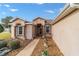 Inviting entryway featuring decorative pillars and potted flowers at 1029 Sw 157Th Ln, Ocala, FL 34473