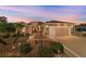 Charming single-story home featuring a well-manicured lawn and two-car garage at dusk at 1029 Sw 157Th Ln, Ocala, FL 34473