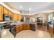 Bright open kitchen area featuring stainless appliances and stone countertops at 1029 Sw 157Th Ln, Ocala, FL 34473