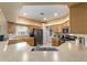 The kitchen features stainless steel appliances, oak cabinets, and a view into the laundry room at 1029 Sw 157Th Ln, Ocala, FL 34473