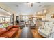 Bright living room with ceiling fan, wood floors, and views of the adjacent kitchen and lanai at 1029 Sw 157Th Ln, Ocala, FL 34473