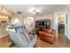 Large living room with wood flooring, neutral tones, and a view into the kitchen and foyer at 1029 Sw 157Th Ln, Ocala, FL 34473