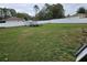 Large, grassy backyard is enclosed with a white vinyl fence to enhance privacy at 11 Pecan Pass Loop, Ocala, FL 34472