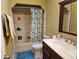 Bathroom featuring a shower/tub combo, toilet, and wood vanity with countertop sink at 11 Pecan Pass Loop, Ocala, FL 34472