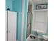 Brightly painted bathroom featuring a shower with sliding doors, commode, and linen closet at 11 Pecan Pass Loop, Ocala, FL 34472