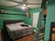 A cozy bedroom with wood floors, a ceiling fan, and decorative deer head mount on the wall at 11 Pecan Pass Loop, Ocala, FL 34472