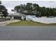 Exterior view of home, featuring white fence, a shed, and a screened-in garage at 11 Pecan Pass Loop, Ocala, FL 34472