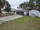 Home exterior featuring solar panels, a screen garage, and an exterior storage shed at 11 Pecan Pass Loop, Ocala, FL 34472