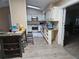 A well-lit kitchen featuring white cabinets, stainless steel appliances, and a skylight at 11 Pecan Pass Loop, Ocala, FL 34472