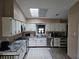 Kitchen view highlighting white cabinets and stainless steel appliances at 11 Pecan Pass Loop, Ocala, FL 34472