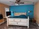 A primary bedroom suite with a white farmhouse-style bed, lamps, and a ceiling fan at 11 Pecan Pass Loop, Ocala, FL 34472