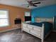 A primary bedroom suite with a white farmhouse-style bed, ceiling fan, and tile floor at 11 Pecan Pass Loop, Ocala, FL 34472