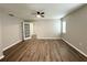 Spacious bedroom featuring wood-look flooring, a ceiling fan, and a bright window at 11484 Sw 76Th Cir, Ocala, FL 34476