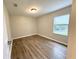 Neutral bedroom featuring laminate floors, a bright window, and neutral paint at 11484 Sw 76Th Cir, Ocala, FL 34476