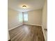 Neutral bedroom featuring laminate floors, a bright window, and neutral paint at 11484 Sw 76Th Cir, Ocala, FL 34476