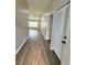 Inviting hallway with modern flooring and neutral paint, leading into the living area at 11484 Sw 76Th Cir, Ocala, FL 34476