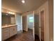 Bright bathroom with double doors, a single vanity, and neutral walls at 13418 Sw 60Th Court Rd, Ocala, FL 34473