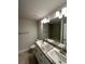 Bathroom featuring double sinks with granite countertop, modern lighting, and tile flooring at 13418 Sw 60Th Court Rd, Ocala, FL 34473