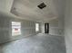 Spacious bedroom featuring a tray ceiling and natural light from two windows at 13418 Sw 60Th Court Rd, Ocala, FL 34473